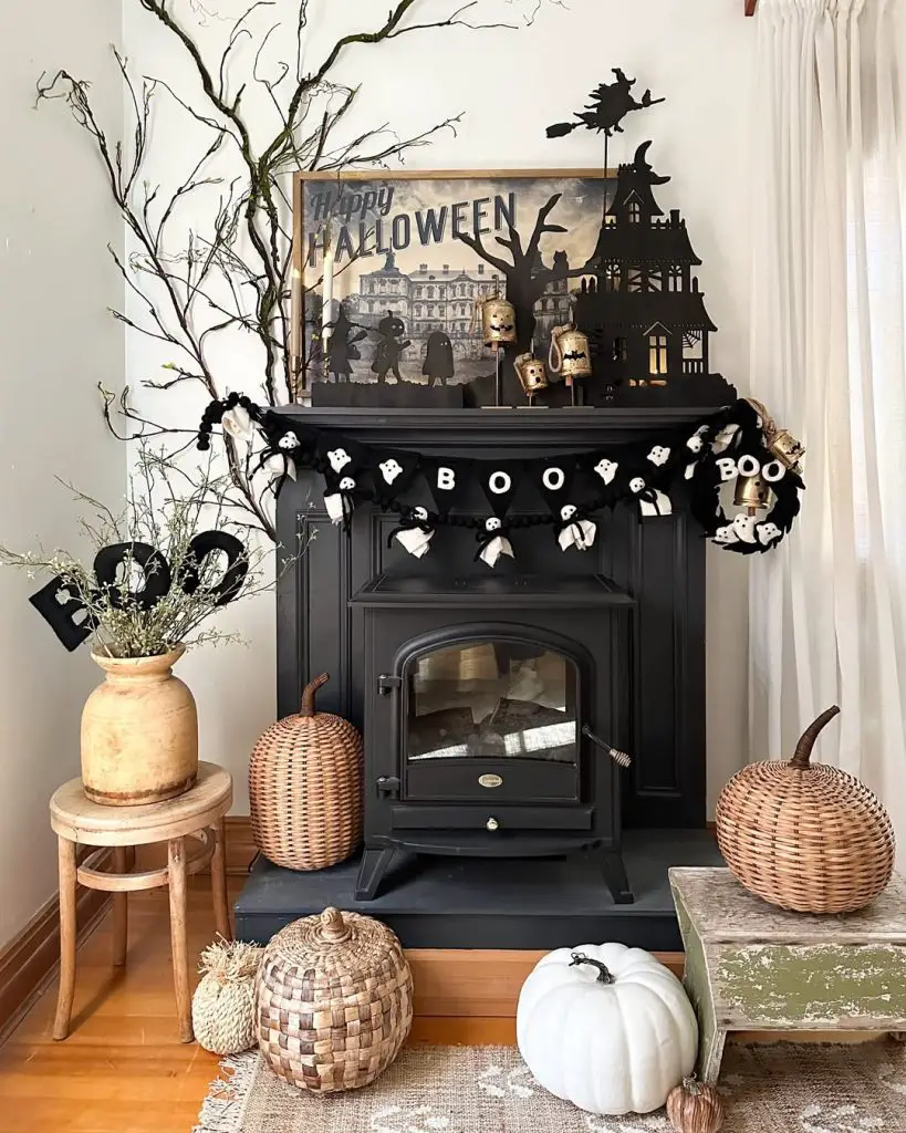Fireplace mantel decorated with Halloween garland and spooky elements