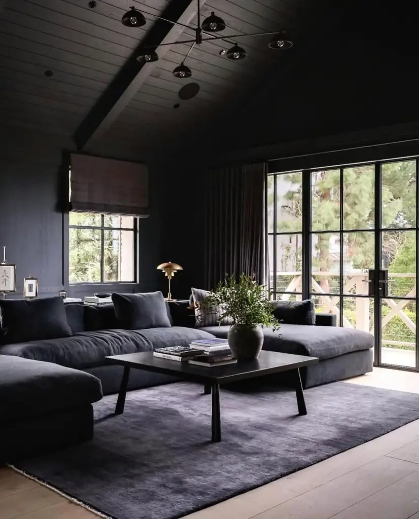 Contemporary cabin living room with wood plank ceilings and forest views