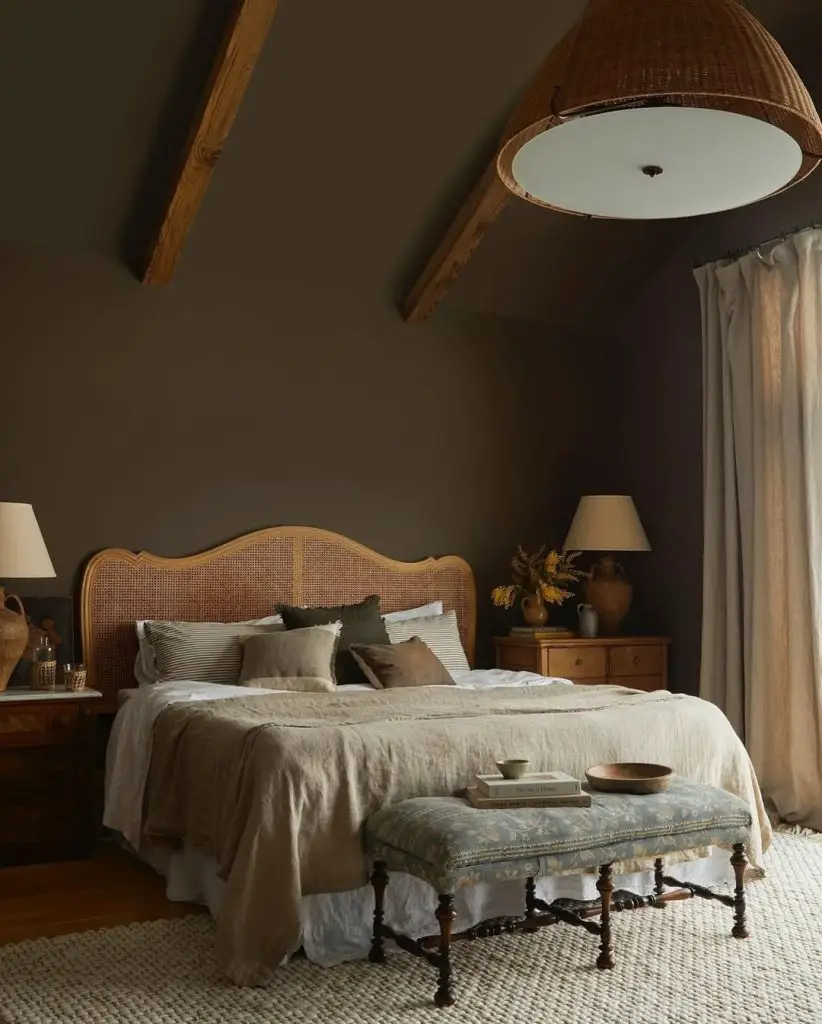 Dark bedroom with cane headboard and exposed ceiling beams