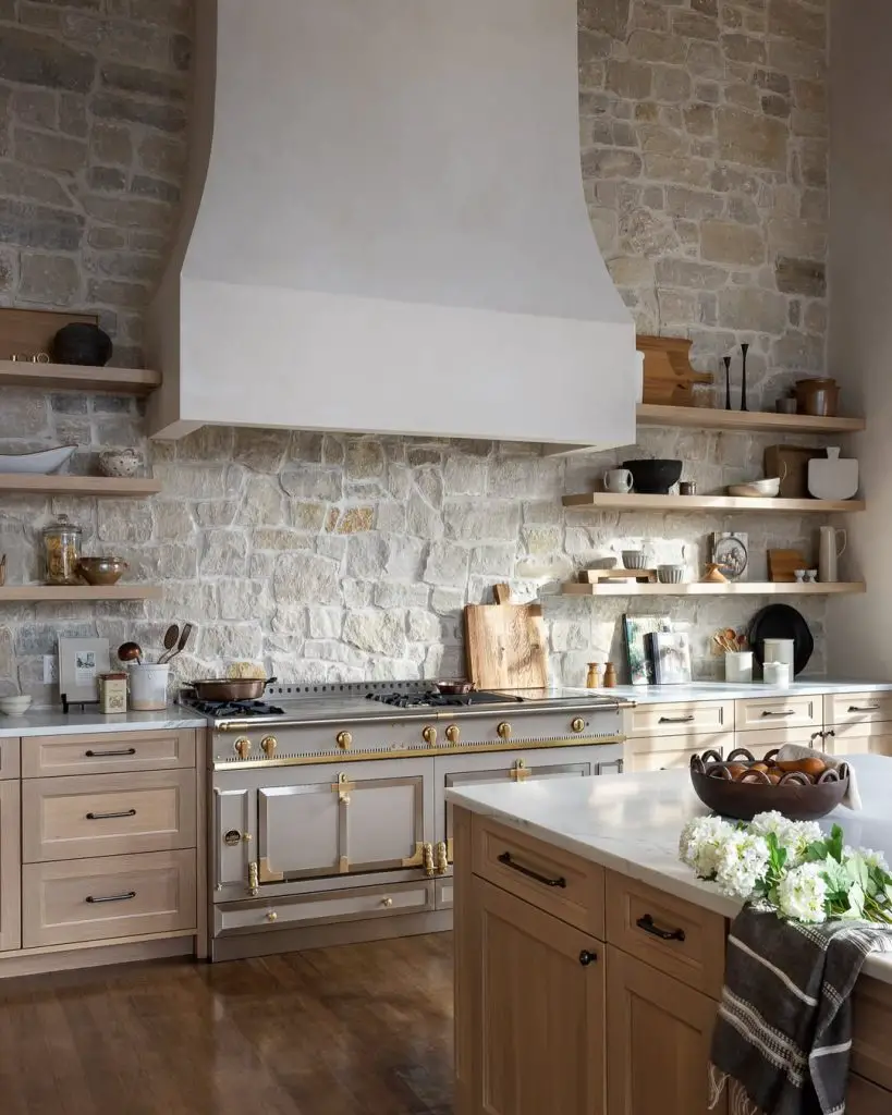 Stone wall kitchen with floating shelves ceramic vessels