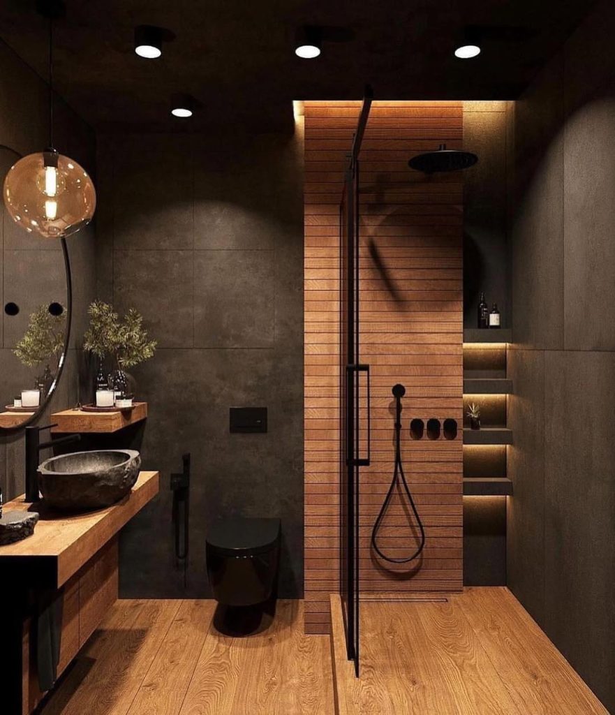 Modern spa bathroom with wood flooring and stone vessel sink