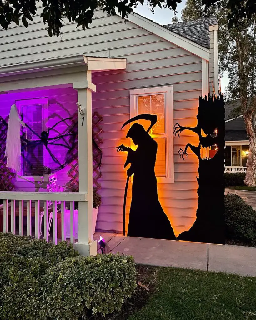 Halloween house with dramatic shadow projections and colored lighting effects