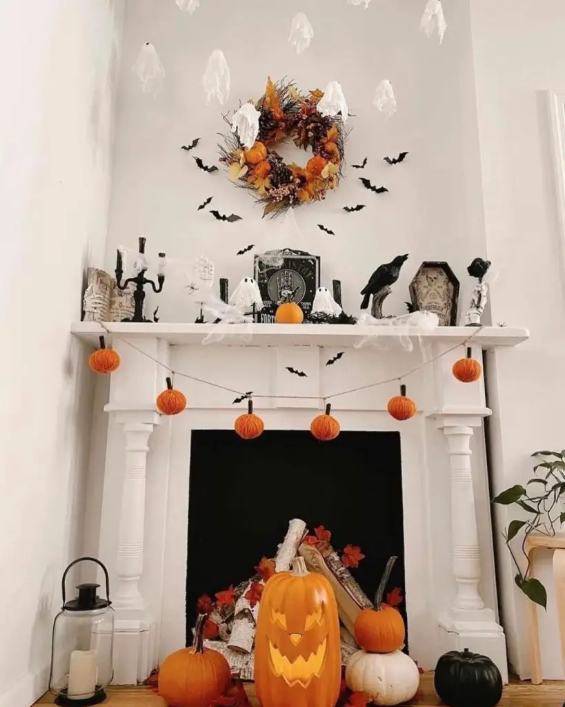 White fireplace decorated with paper ghosts and autumn elements