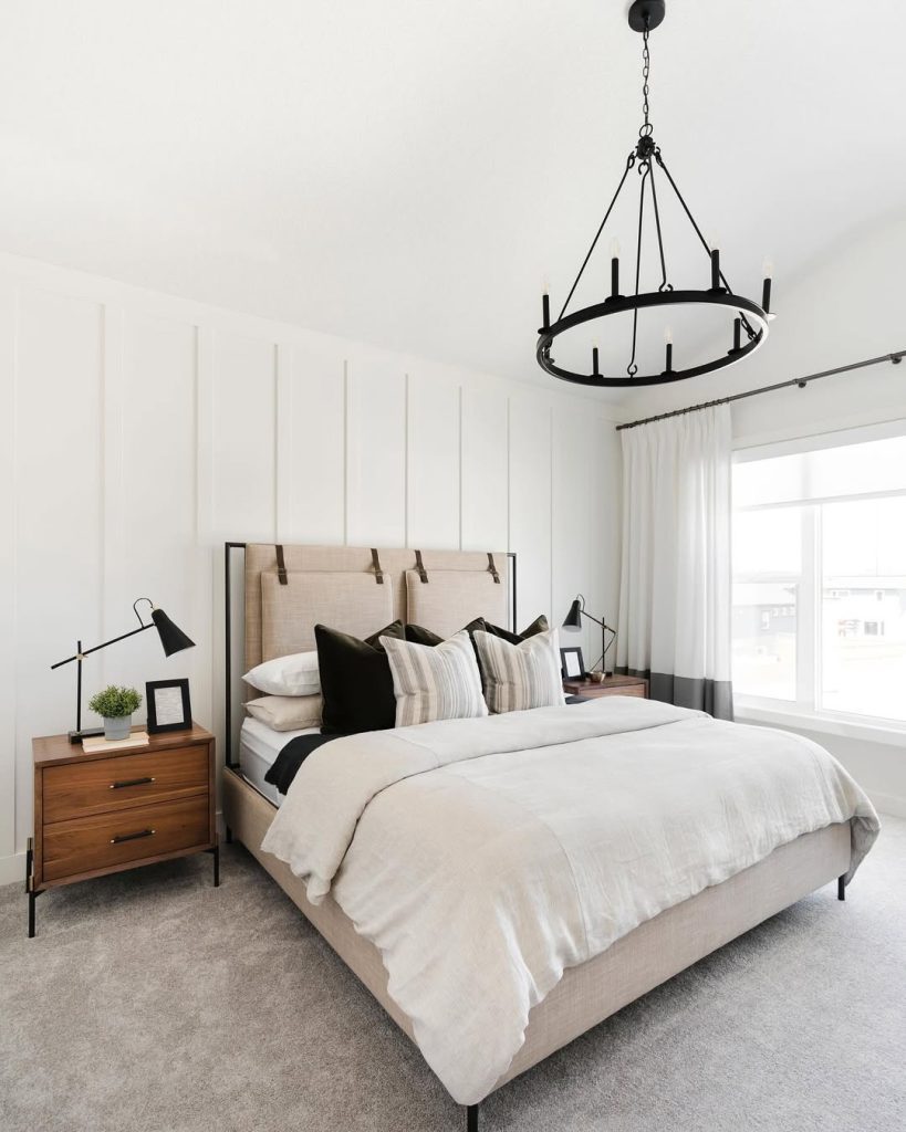 Modern industrial bedroom with circular chandelier and leather headboard