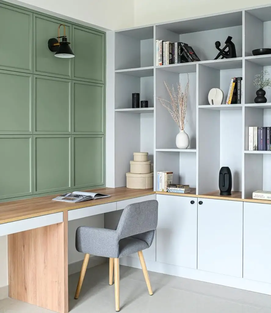 Corner library with sage cabinets and L-shaped desk