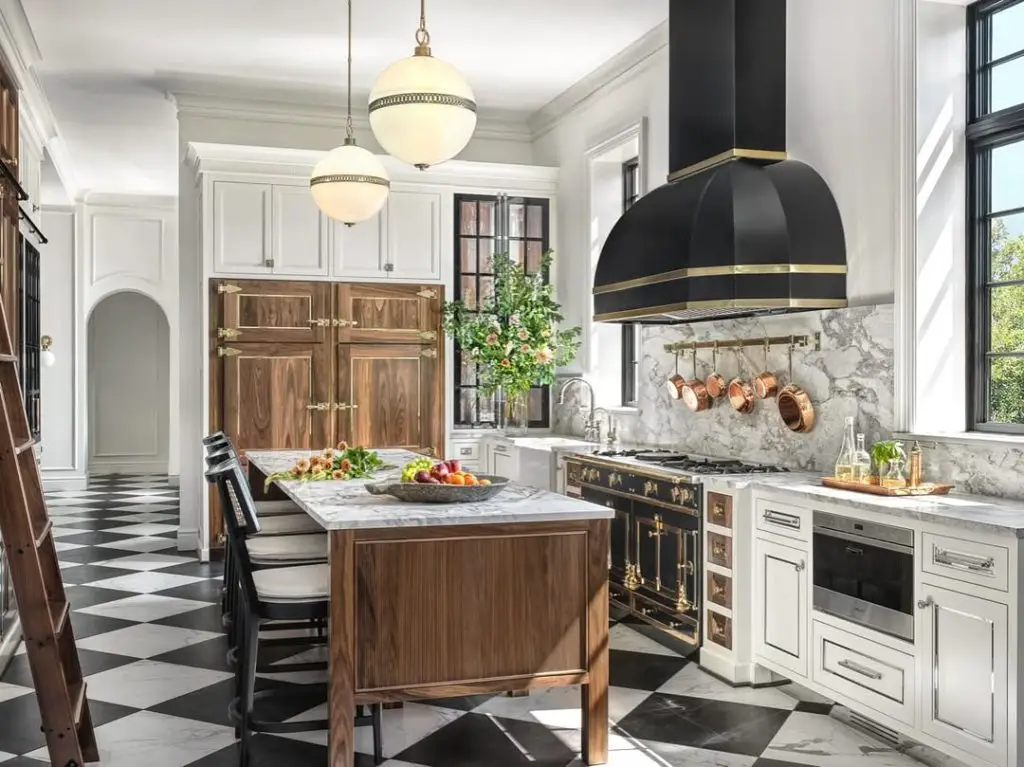 Classic kitchen with white cabinets, black appliances, checkered floors