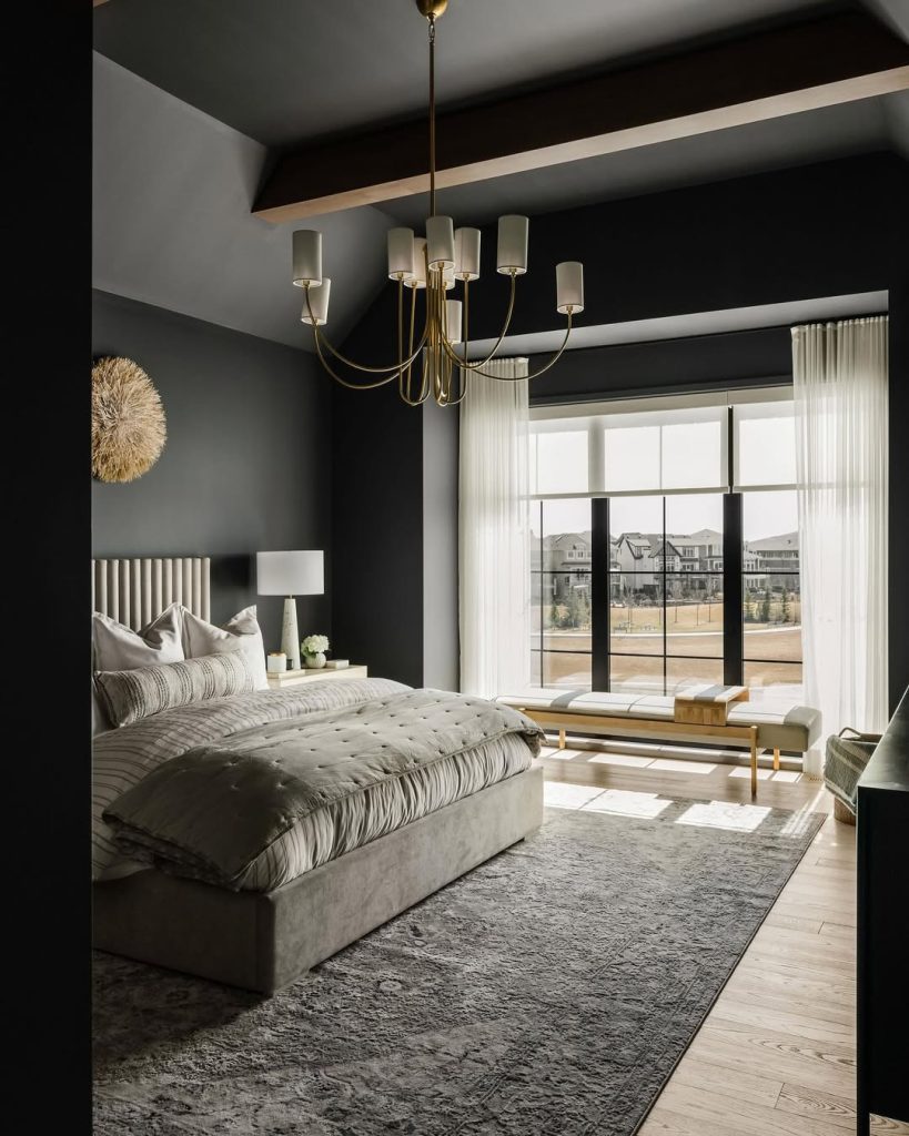 Dark contemporary bedroom with brass chandelier and fluted headboard