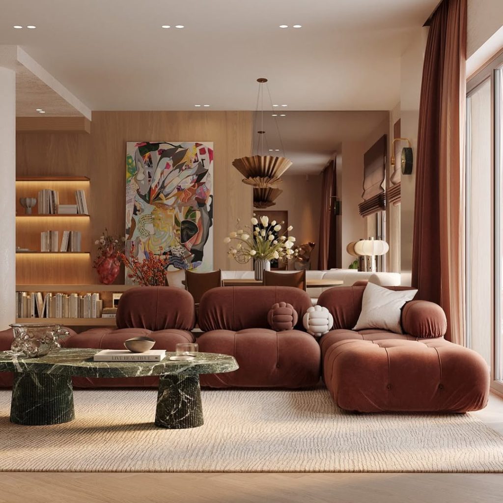 Modern living room with curved sofa, marble table, and warm wood accents
