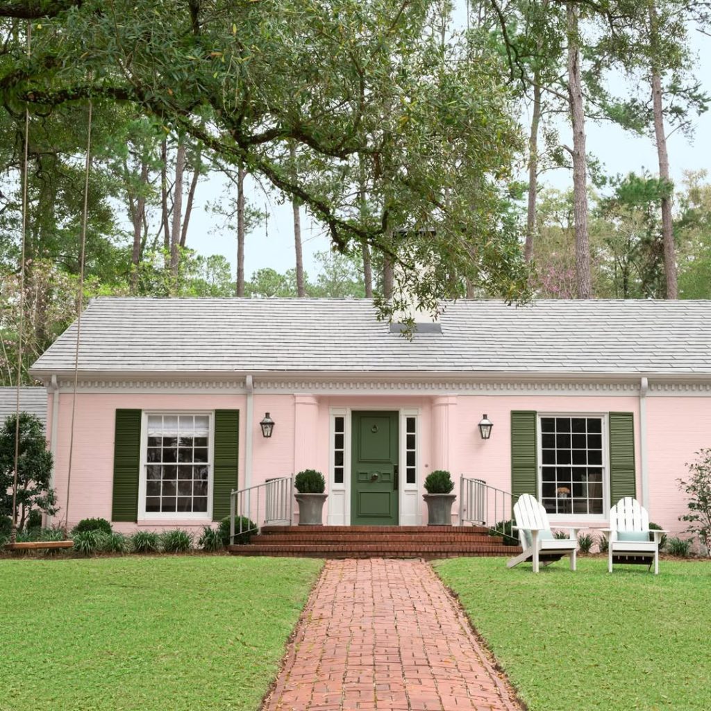 Pink cottage with green shutters brick walkway