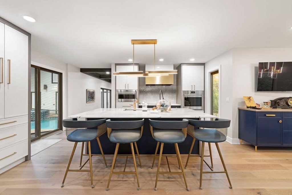 Modern kitchen with navy blue island and brass accents