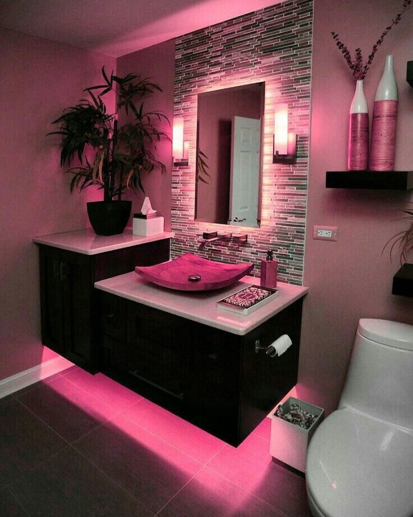 Modern pink bathroom with floating vanity and LED lighting