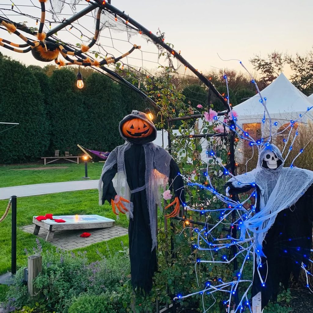 Halloween backyard party with pumpkin head figure and lights