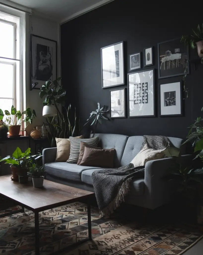 Gray sofa with black walls, abundant plants, gallery wall artwork