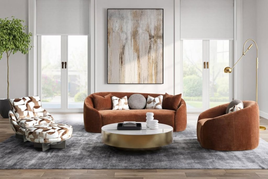 Curved terracotta sofa with patterned chair and brass coffee table