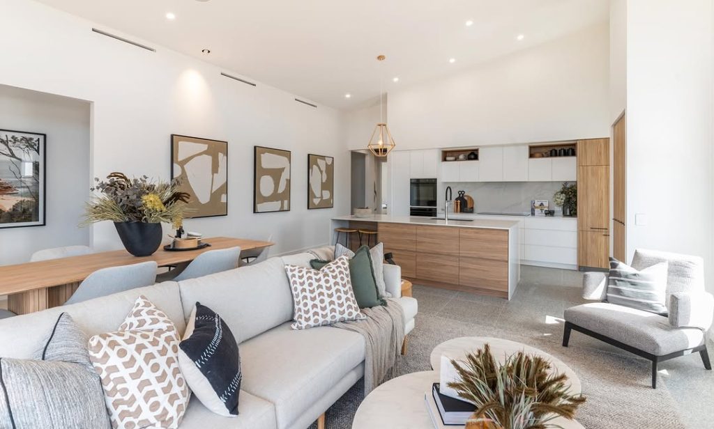Open plan kitchen and living room with neutral tones and wood accents