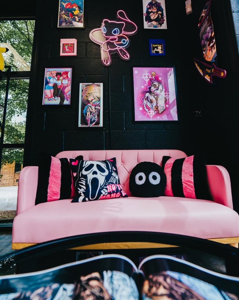 Pink sofa with anime wall art and neon lighting