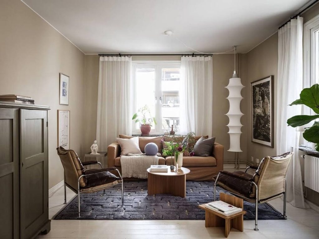  Beige living room with leather chairs and modern lighting