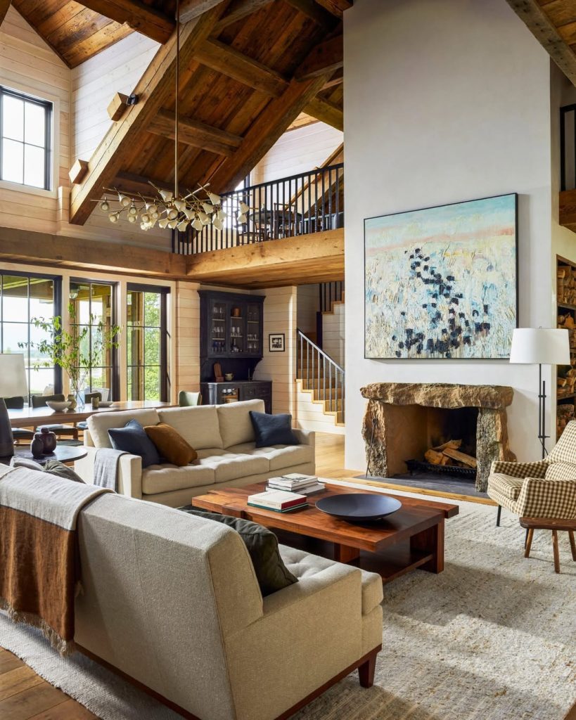 Rustic living room with exposed beams and stone fireplace