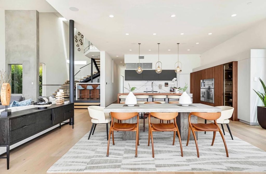 Open concept kitchen dining room with marble island and wood cabinets