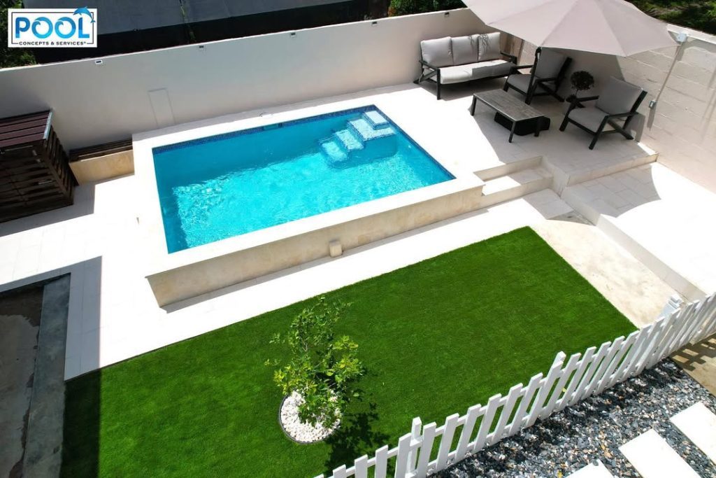 Rooftop pool with modern furniture and white decking design