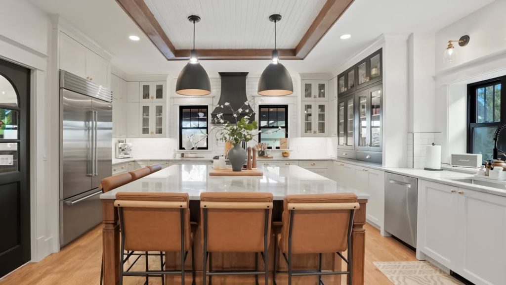  White kitchen with coffered ceiling and dark pendant lights