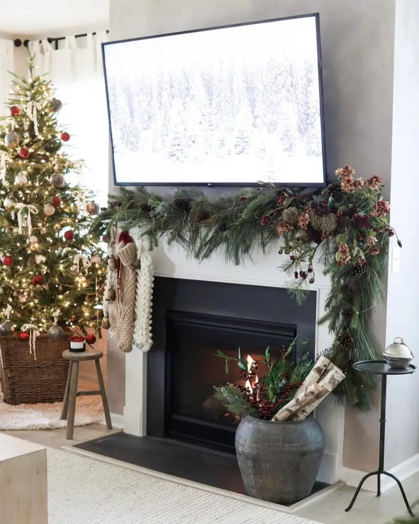Modern fireplace with natural Christmas garland and neutral decorations