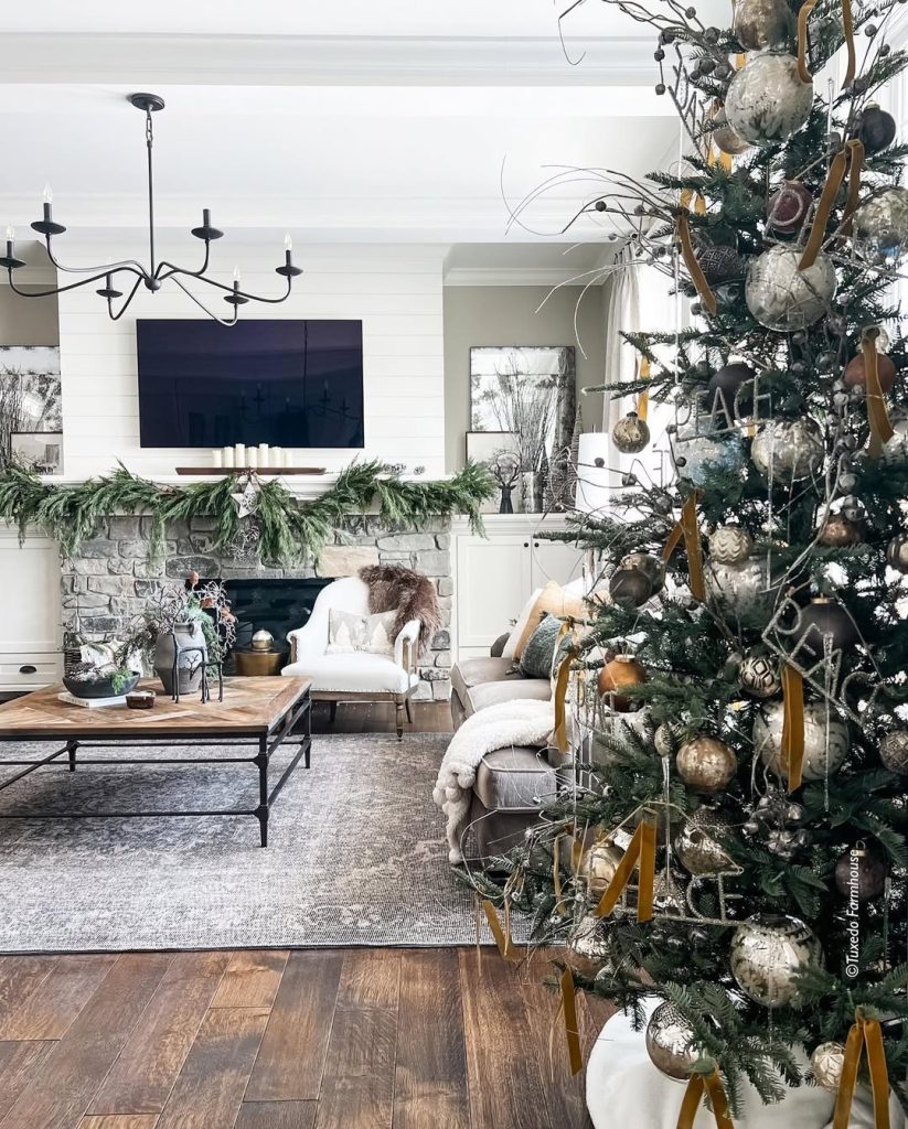Modern farmhouse living room with gold Christmas tree and stone fireplace