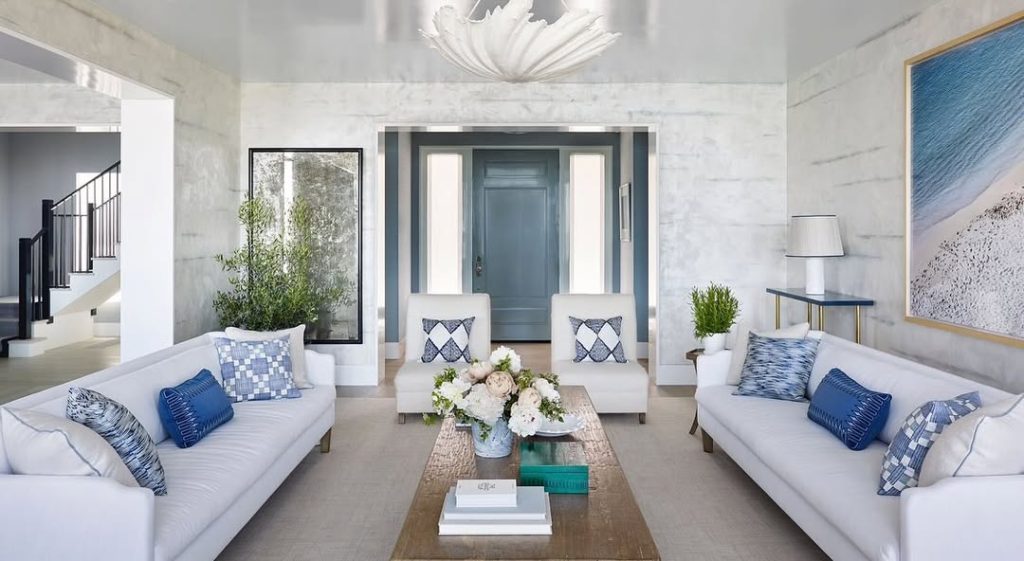 Modern living room with white sofas and blue accents