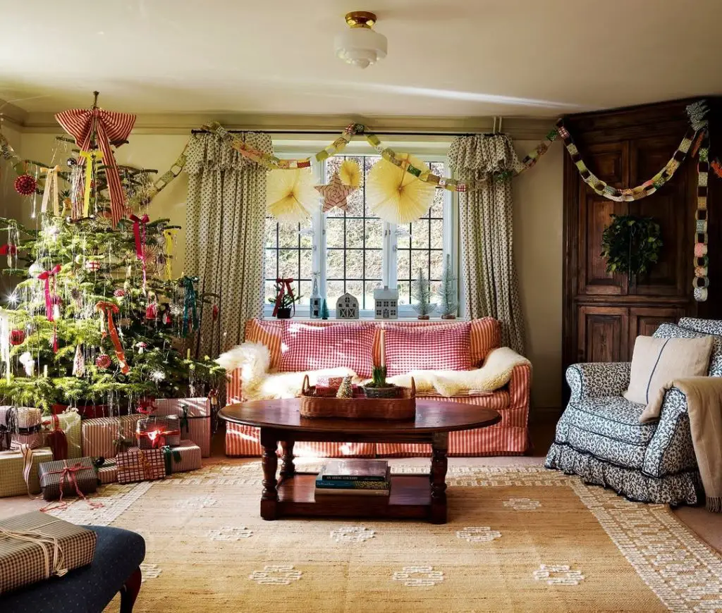 Country cottage living room with red gingham sofa and Christmas tree