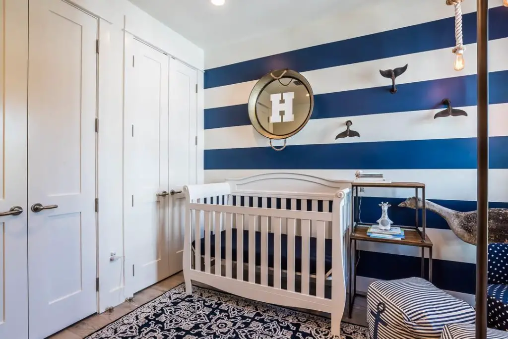 Blue built-in bunk beds with nautical rope lighting details.