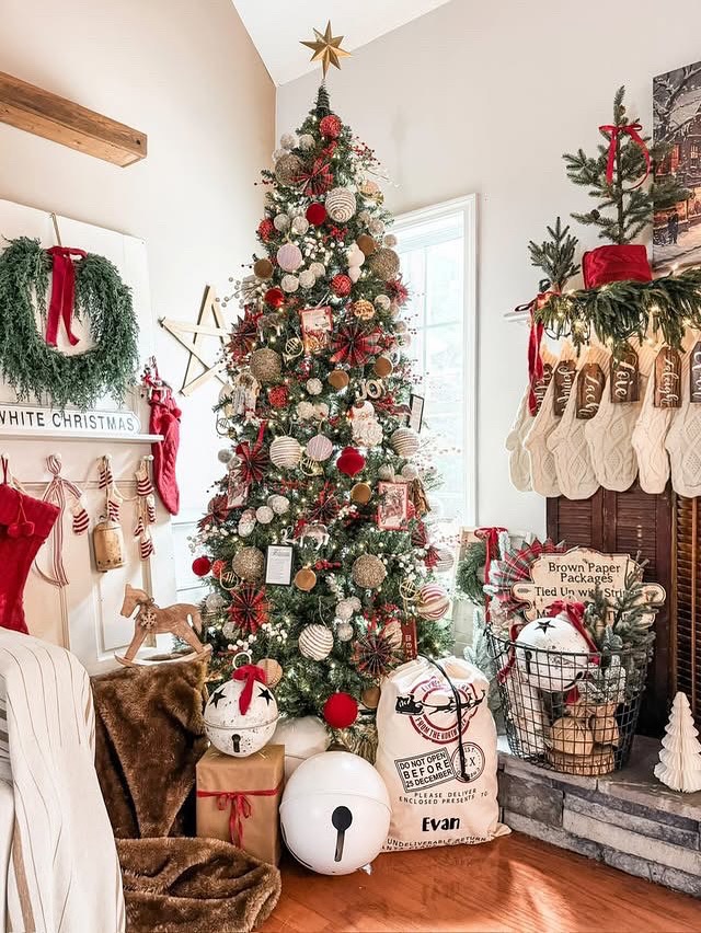Farmhouse Christmas corner with full decorated tree red ornaments and wrapped gifts