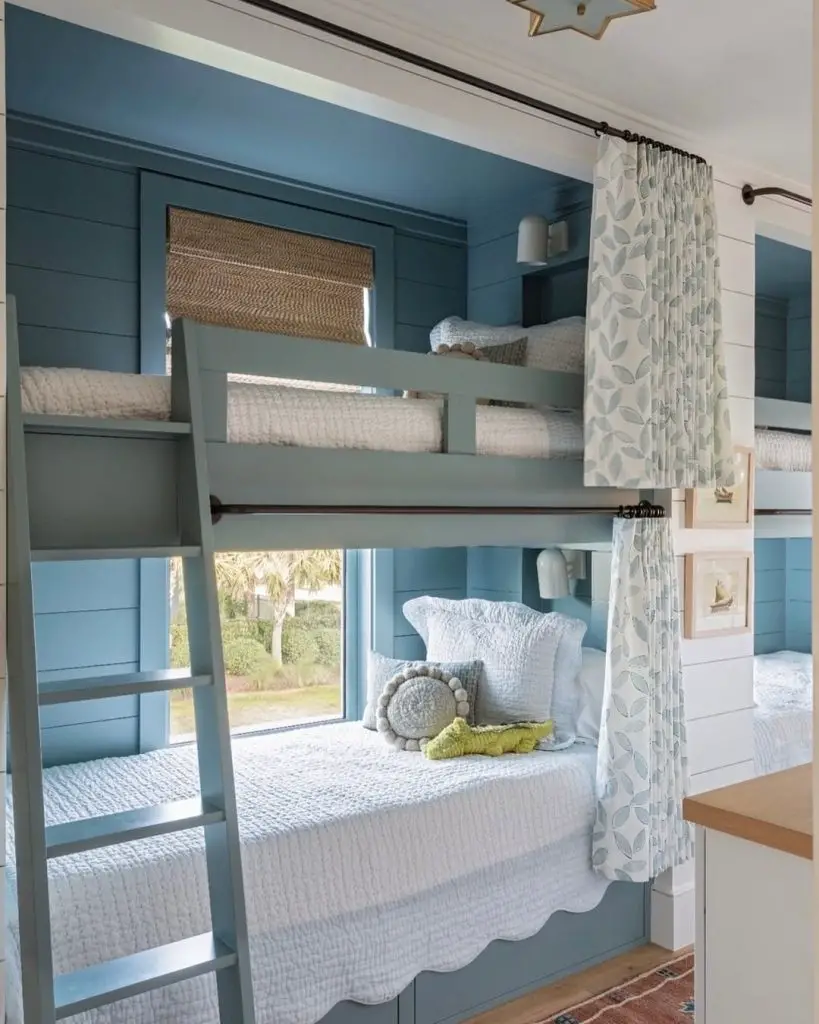 Green coastal bunk beds with shiplap walls and textured rug.