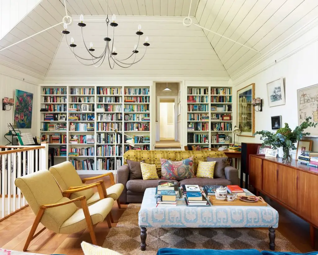 Home library with floor-to-ceiling bookshelves and comfortable seating area