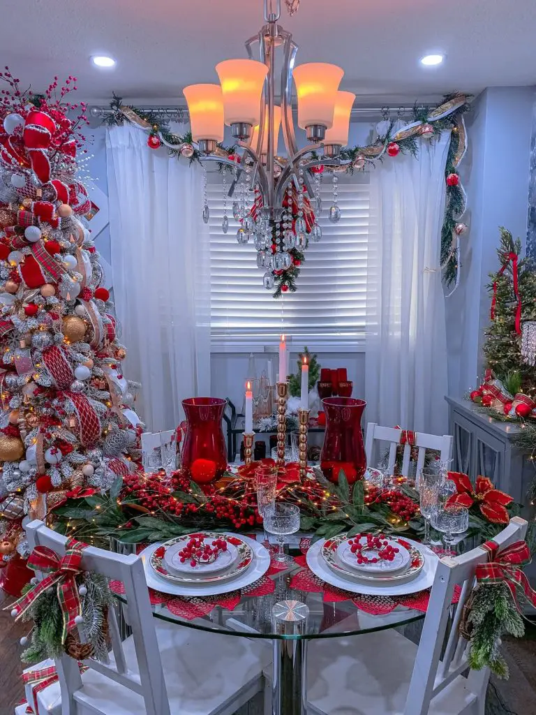 Elegant Christmas dining room with red decorations and glass table
