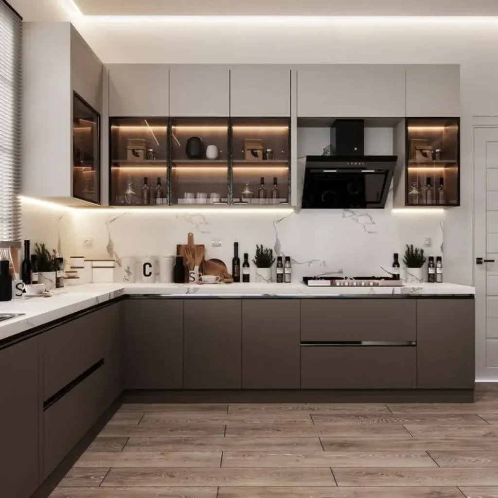 Kitchen with illuminated glass cabinets marble backsplash and gray cabinetry