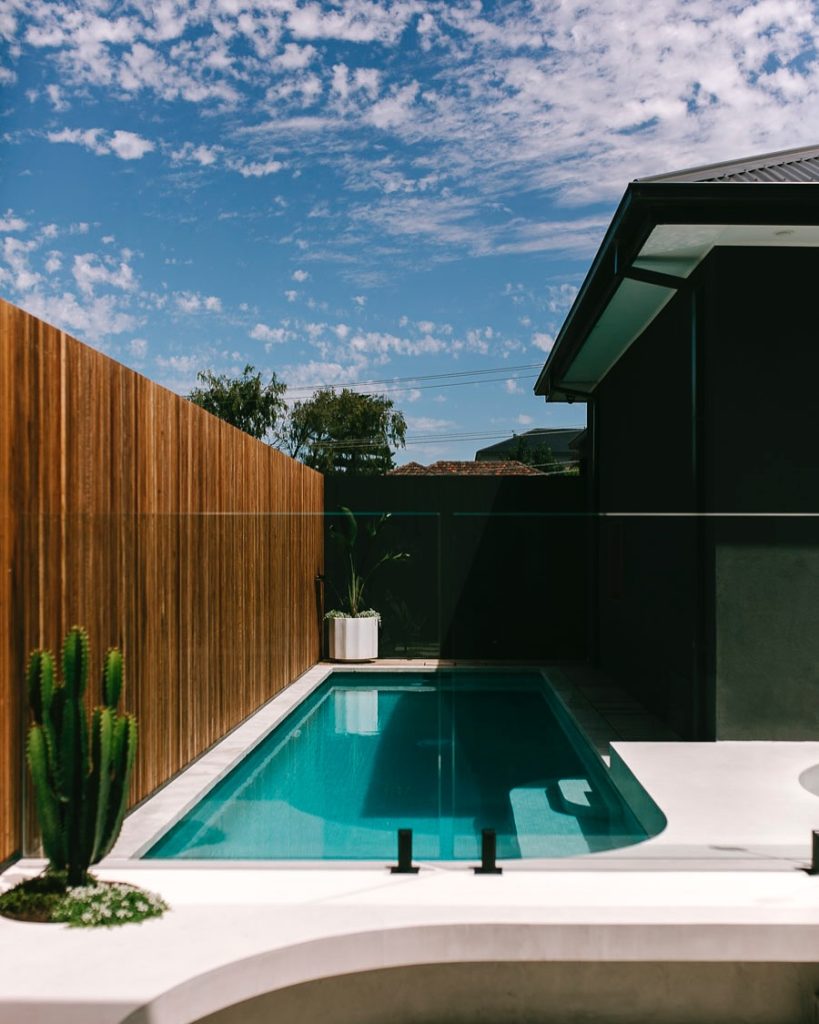 Modern rectangular pool with timber screens and minimalist landscaping