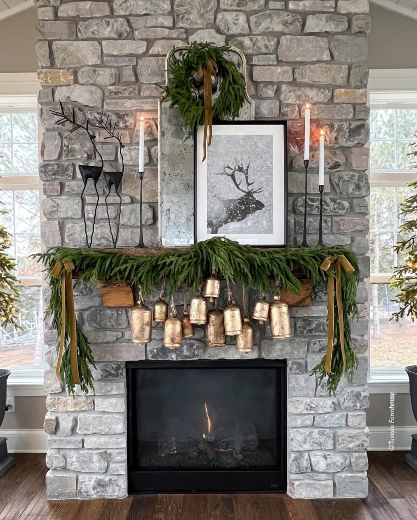 Stone fireplace mantel decorated with Christmas garland candles