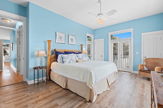 Peaceful blue bedroom with wooden headboard and natural textures