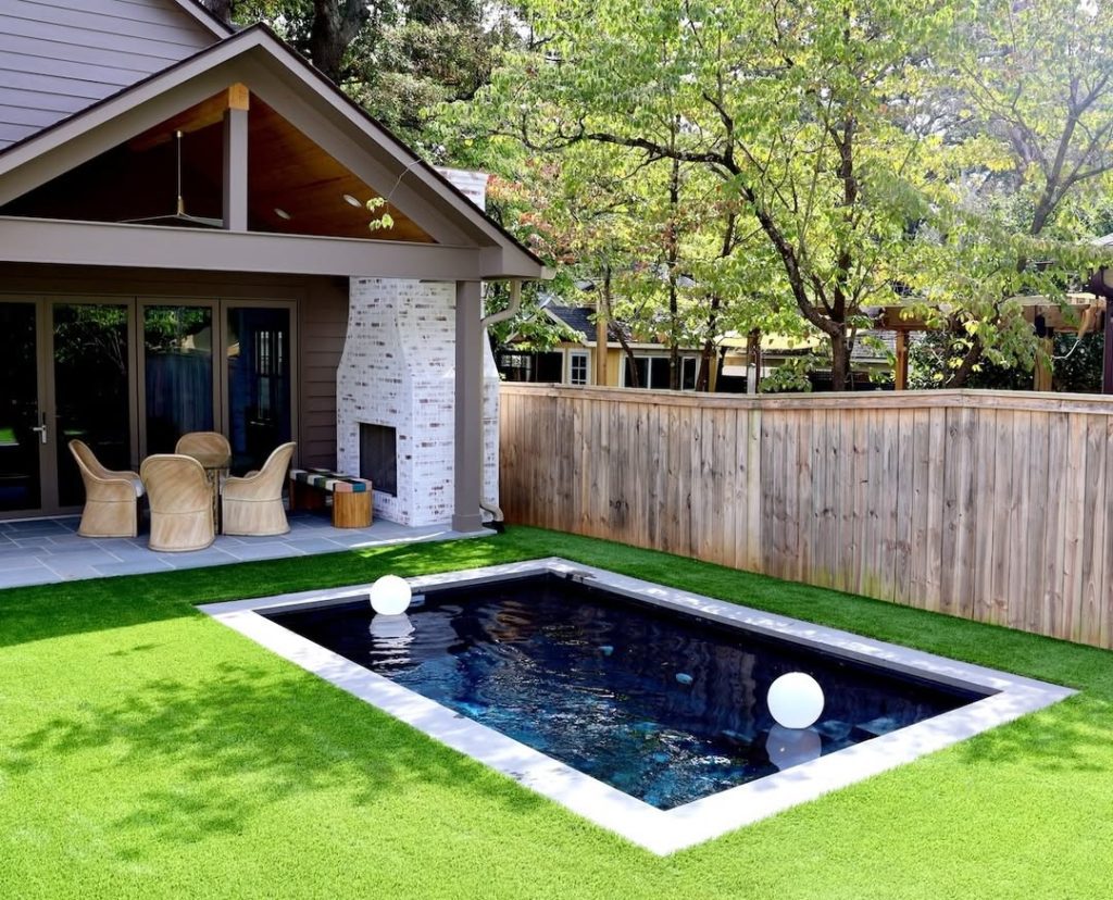 Small rectangular pool with artificial grass and covered outdoor pavilion