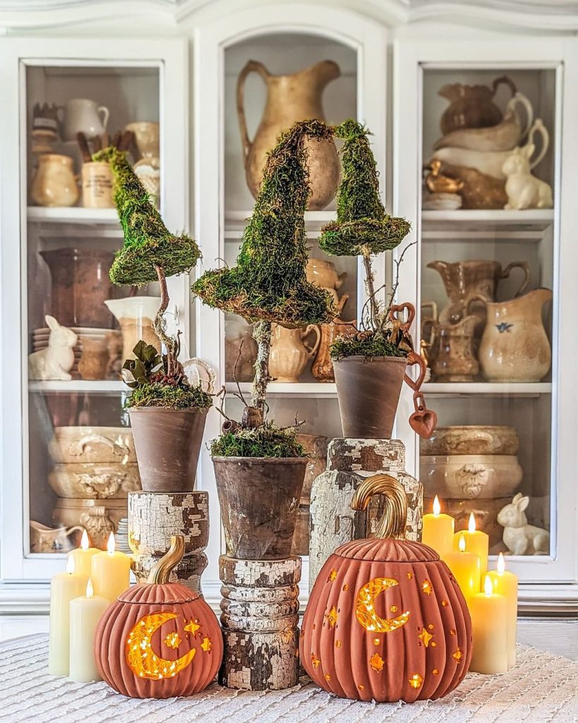 Moss covered letters on wood blocks with carved pumpkins and candles