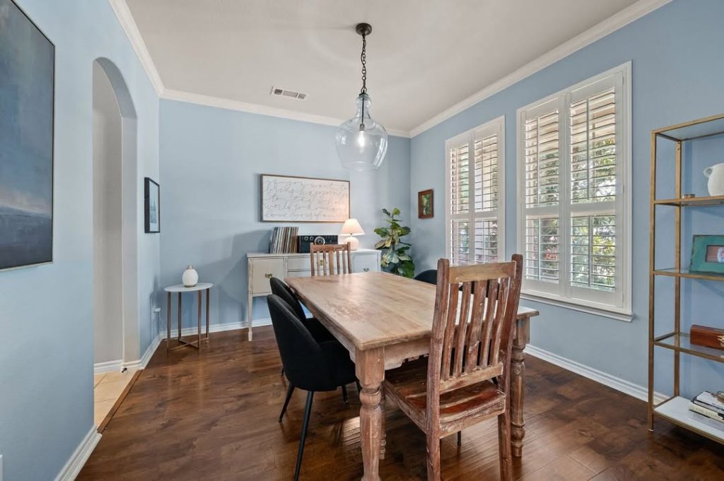 Formal dining room with blue walls and wooden table