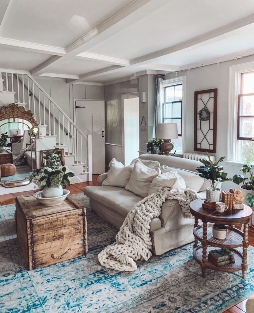 Farmhouse living room with beams neutral furniture plants