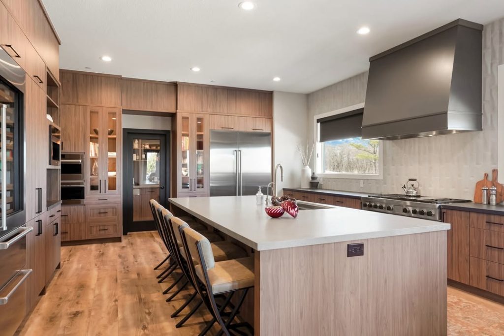 Wood grain kitchen with stainless appliances and large island