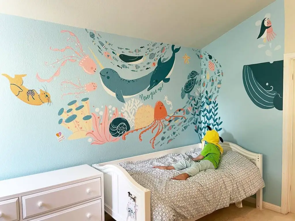 Aqua nursery featuring colorful ocean wall art and sea creatures
