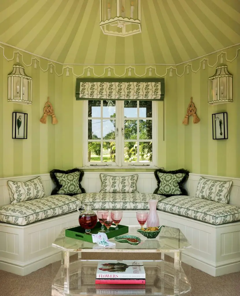 Living room with botanical wallpaper ceiling and patterned sofa