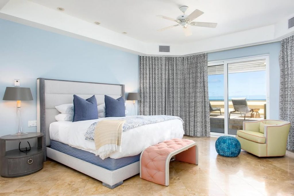 Modern blue bedroom with contemporary furniture and ocean views
