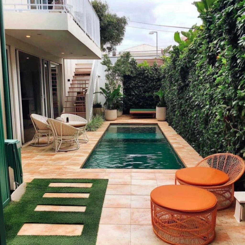 Long narrow pool in urban courtyard with timber deck