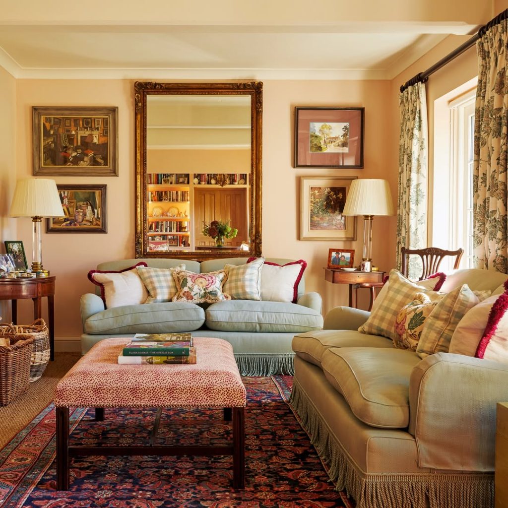 Pink living room with fireplace and green accent pieces