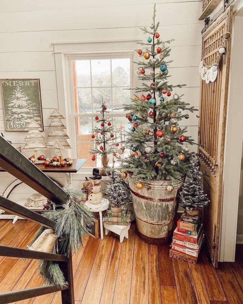 Christmas tree in wooden barrel with colorful ornaments
