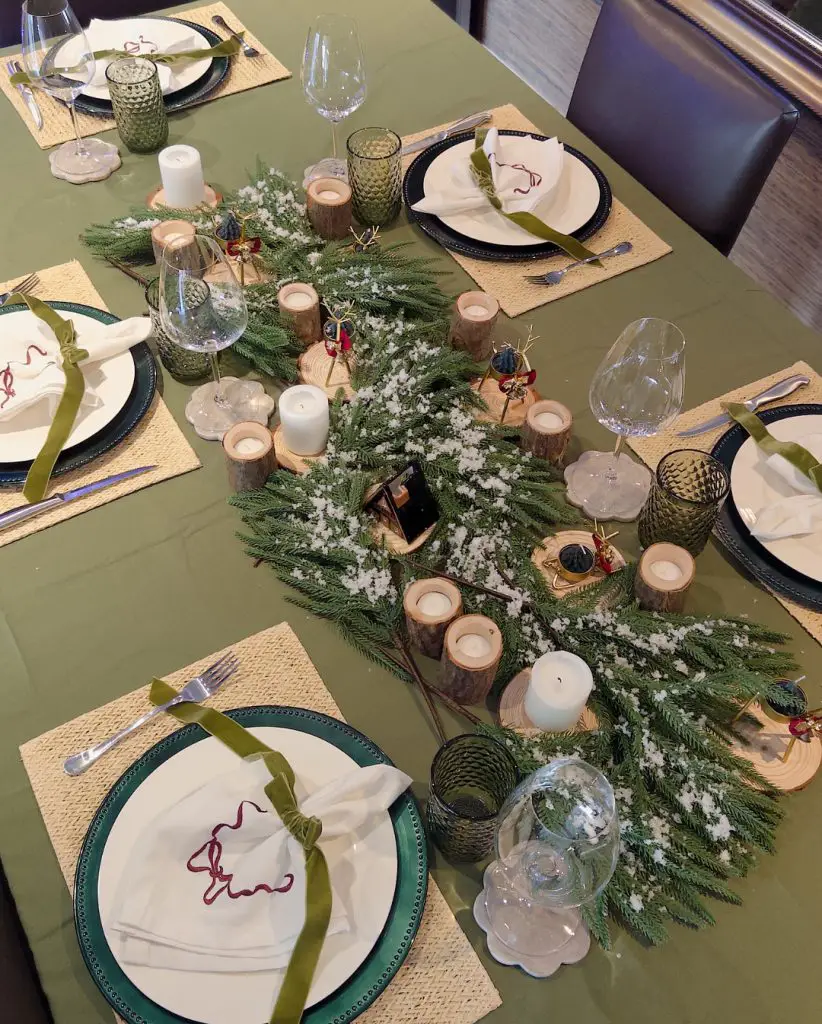 Christmas table with copper accents and ceramic house decoration